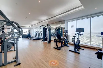 a gym with treadmills and exercise equipment in a building at Luxury Apt - Rooftop Pool - City View in Dubai