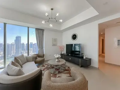 a living room with a couch and a tv at Modern 3BR in Marina, Sea View Next to Bluewater - 28AB02 in Dubai