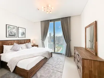a bedroom with a bed and a large window at Modern 3BR in Marina, Sea View Next to Bluewater - 28AB02 in Dubai