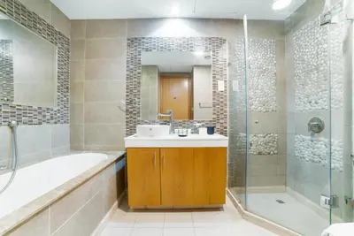 a bathroom with a sink and a tub and a shower at Vacay Lettings - Iris blue spectacular Marina view Apartment in Dubai
