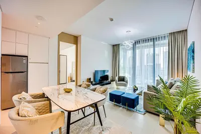 a living room with a dining table and a living room at Spacious 1BD apartment in Address Beach Residence in Dubai