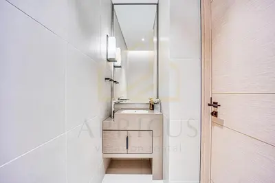 a bathroom with a sink and a mirror next to a door at Spacious 1BD apartment in Address Beach Residence in Dubai