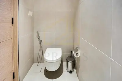 a bathroom with a toilet and a trash can at Spacious 1BD apartment in Address Beach Residence in Dubai