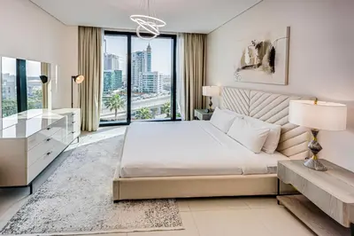 a bedroom with a large bed and a large window at Spacious 1BD apartment in Address Beach Residence in Dubai