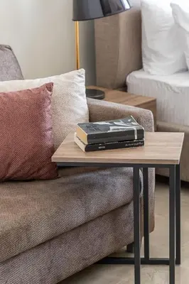 a table with two books on top of a couch at Frank Porter - Majestique 1 in Dubai