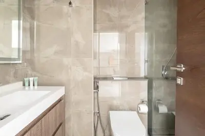 a bathroom with a shower and a toilet and a sink at Frank Porter - Majestique 1 in Dubai