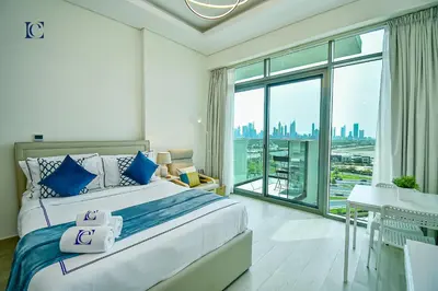 a bedroom with a large bed and a large window at Luxury Escapes - Brand New Studio with View - Azizi Farhad Jaddaf in Dubai