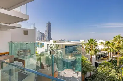 a glass balcony with a view of a city at Daniels Five Palm Sea View 2BR with Maids Room in Dubai