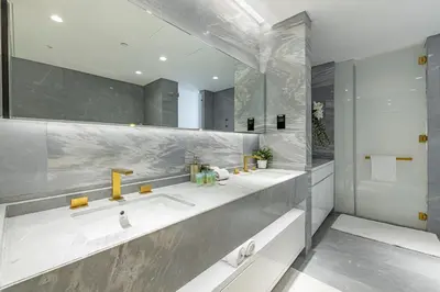 a bathroom with two sinks and a mirror at Daniels Five Palm Sea View 2BR with Maids Room in Dubai