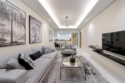 a living room with a couch and a table at Paramount Midtown Deluxe 1 BR Apartment with Full Burj-Khalifa View in Dubai