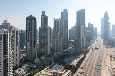 an aerial view of a city with tall buildings at Infinity Pool & Burj Khalifa View l Luxe Paramount in Dubai