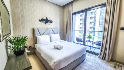 a bedroom with a large bed and a large window at STAY BY LATINEM Luxury 1BR Holiday Home CV A2304 near Burj Khalifa in Dubai