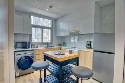 a kitchen with a washer and dryer in it at The Smart Concierge - DEC Tower in Dubai