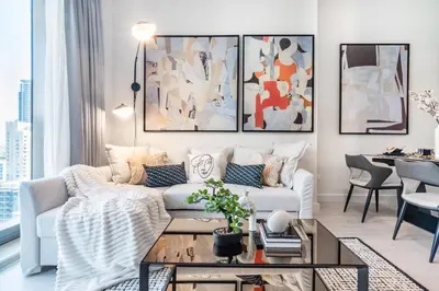 a living room with a couch and a table at The Smart Concierge - Sparkle tower in Dubai