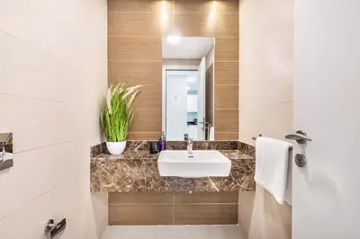 a bathroom with a sink and a mirror at The Smart Concierge - Sparkle tower in Dubai