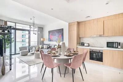 a kitchen and dining room with a table and chairs at The Smart Concierge - Beach Vista Tower in Dubai