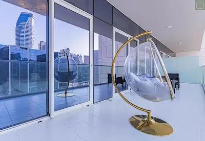 a room with two chairs in a building with windows at ONYX - Full Burj Khalifa View Dubai 2 BEDROOM APARTMENT - DOWNTOWN DUBAI in Dubai