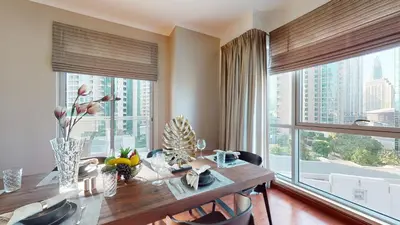 a dining room with a table and large windows at Stylish 2-Bed Apt Burj Khalifa and Fountain Views in Dubai