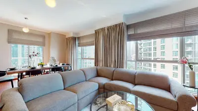 a living room with a couch and a table at Stylish 2-Bed Apt Burj Khalifa and Fountain Views in Dubai