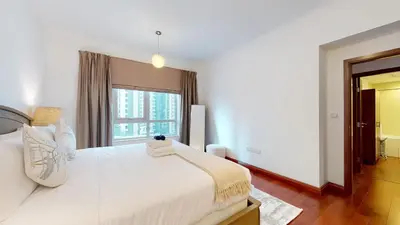 a bedroom with a large white bed with a window at Stylish 2-Bed Apt Burj Khalifa and Fountain Views in Dubai