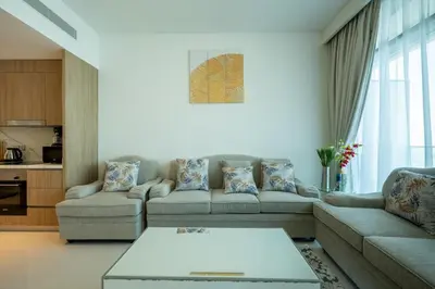 a living room with two couches and a table at Emaar Beach Vista Tower 1 2BHK FAHH in Dubai