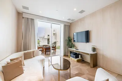 a living room with a couch and a tv at Daniels Five Palm 2BR with Garden View in Dubai