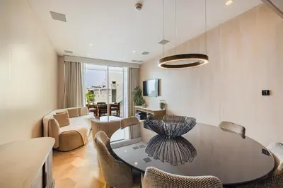 a dining room with a table and chairs at Daniels Five Palm 2BR with Garden View in Dubai