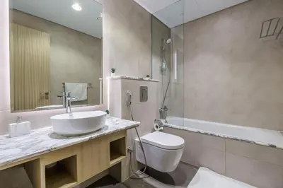 a bathroom with a sink and a toilet and a tub at GuestReady - Fabulous 2BR with Burj Khalifa view in Dubai