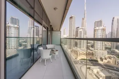 a balcony with chairs and a view of the city at GuestReady - Fabulous 2BR with Burj Khalifa view in Dubai