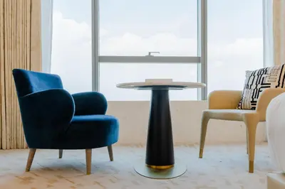 a chair and a table in a room at Studio Apartment in The Palm Tower 5 Star Facilities in Dubai