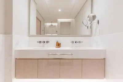 a bathroom with two sinks and a mirror at Studio Apartment in The Palm Tower 5 Star Facilities in Dubai