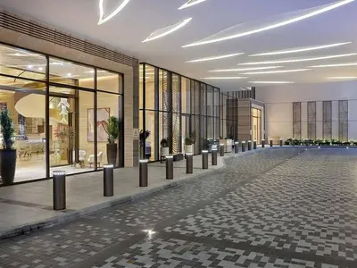 a lobby of a building with a lot of windows at Studio Apartment in The Palm Tower 5 Star Facilities in Dubai