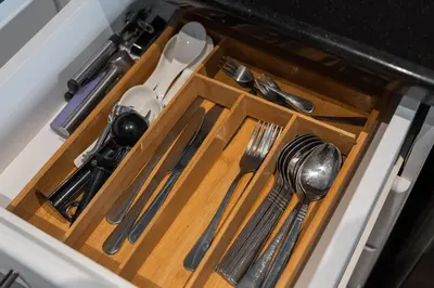a drawer in a kitchen with utensils at Luxury studio in Discovery Gardens near metro in Dubai