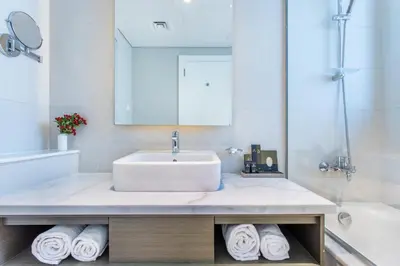 a bathroom with a sink and a tub and a sink at The S Holiday Homes Canal view Studio and One Bedroom Apartments, Damac Maison Prive in Dubai