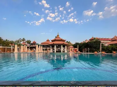 a large swimming pool in front of a resort at Marvelous private beach apartment in Palm Dubai within Anantara 5 star resort in Dubai