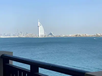 a view of the water with a city in the background at Marvelous private beach apartment in Palm Dubai within Anantara 5 star resort in Dubai