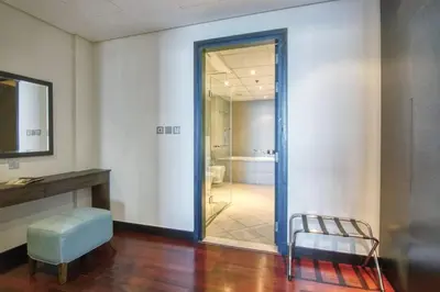 a room with a door leading to a bathroom at Marvelous private beach apartment in Palm Dubai within Anantara 5 star resort in Dubai