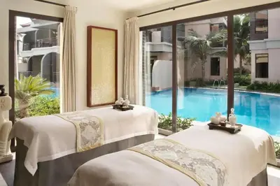 two beds in a room with a swimming pool at Marvelous private beach apartment in Palm Dubai within Anantara 5 star resort in Dubai