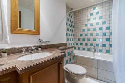 a bathroom with a sink and a toilet and a tub at GuestReady - Luxe Arabian Apartment in Downtown in Dubai