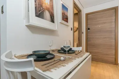 a kitchen with a table with a bowl and glasses at Stunning Apt Marina view with Balcony in Dubai