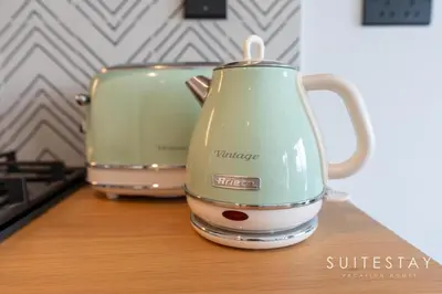 a toaster and toaster sitting on a counter at Chic One Bedroom Suite with Cozy Interiors in Dubai