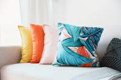 a pillow on a couch with colorful pillows at Charming 1BR in The Greens, Near Metro in Dubai