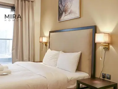 a hotel room with a bed and a table at Mira Holiday Homes - Lovely 1 bedroom in Downtown in Dubai