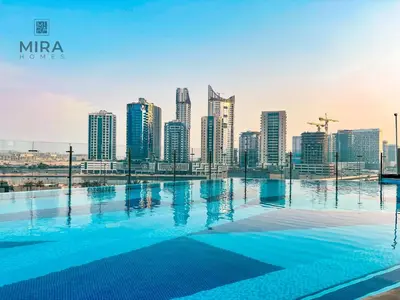a swimming pool with a city skyline in the background at Mira Holiday Homes - Lovely 1 bedroom in Downtown in Dubai