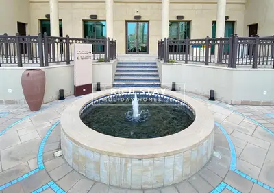 a fountain in the middle of a building with stairs at Upgraded 1BR in Downtown with Burj Khalifa View in Dubai