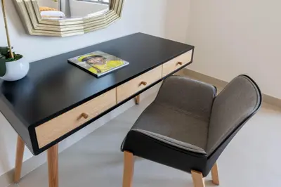 a black desk with a chair and a mirror at Ultimate Stay / 7 people / Spacious / Dubai Creek with Marina Views in Dubai