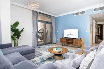 a living room with a couch and a tv at Ultimate Stay / 7 people / Spacious / Dubai Creek with Marina Views in Dubai