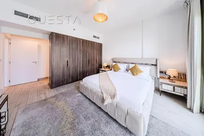 a bedroom with a large white bed and a wooden wall at Lamtara 1 - Madinat Jumeirah Living, Jumeirah in Dubai