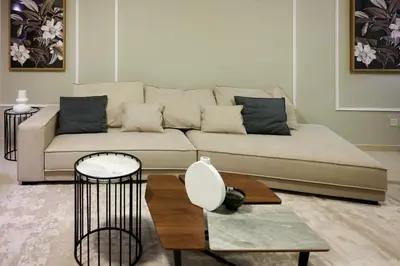 a living room with a couch and a table at Palmar One Bedroom with Private Beach! in Dubai