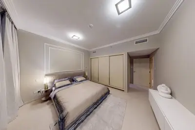 a bedroom with a bed and a couch in it at Palmar One Bedroom with Private Beach! in Dubai